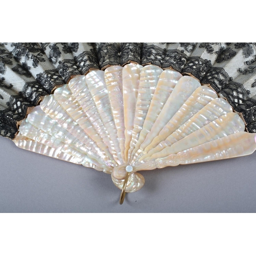 76 - c.1880’s a pink mother of pearl fan mounted with cream satin and overlaid with black handmade lace w... 