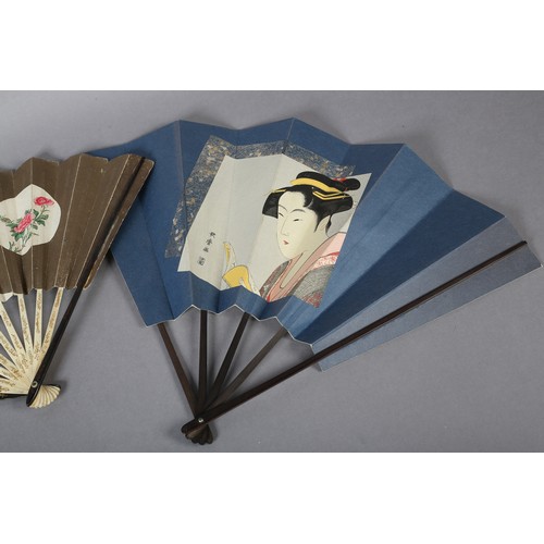 130B - Two large Japanese fans, the first with a central portrait of a geisha, with hair accessories and co... 