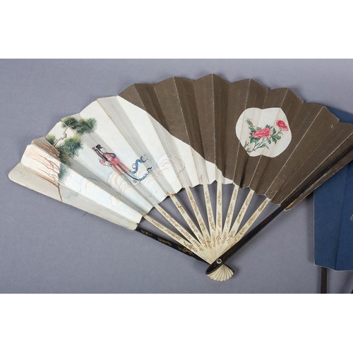 130B - Two large Japanese fans, the first with a central portrait of a geisha, with hair accessories and co... 