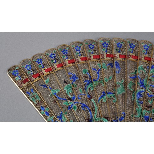 137 - A Chinese Qing dynasty filigree silver gilt metal brisé fan, painted in vibrant green and blue clois... 