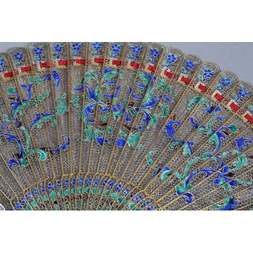 137 - A Chinese Qing dynasty filigree silver gilt metal brisé fan, painted in vibrant green and blue clois... 