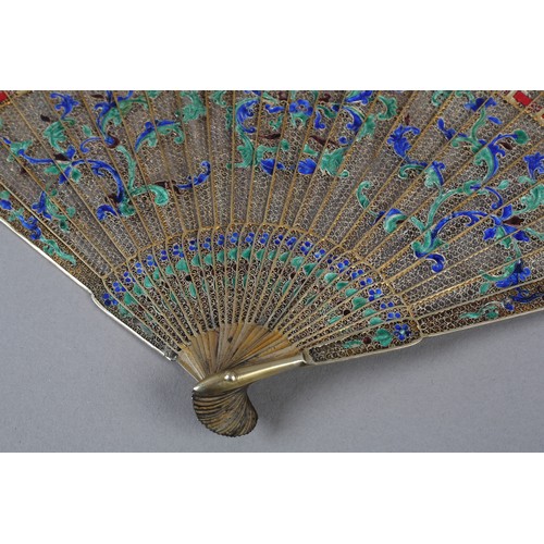 137 - A Chinese Qing dynasty filigree silver gilt metal brisé fan, painted in vibrant green and blue clois... 