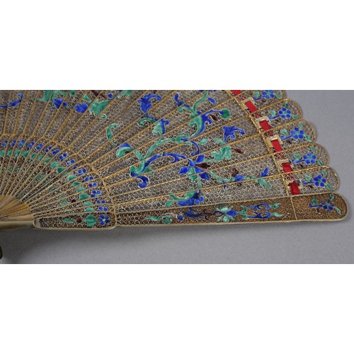 137 - A Chinese Qing dynasty filigree silver gilt metal brisé fan, painted in vibrant green and blue clois... 