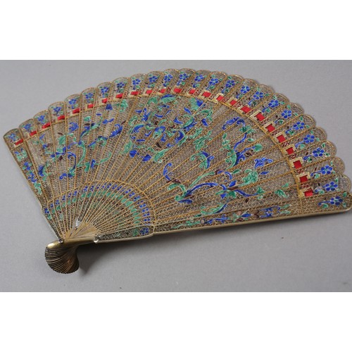 137 - A Chinese Qing dynasty filigree silver gilt metal brisé fan, painted in vibrant green and blue clois... 