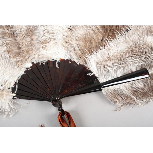 103 - A good female ostrich feather fan, the monture of tortoiseshell, the loop fitted with a n extravagan... 