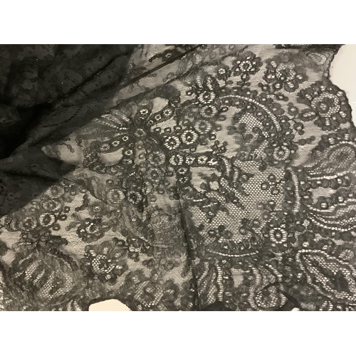 211 - Antique lace: a 19th century black rectangular machine lace shawl with floral design, approx. 180cm ... 