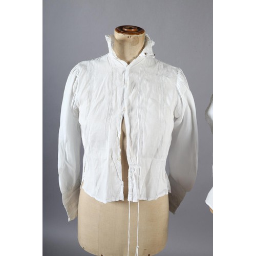 260 - An ornate Edwardian fine white cotton blouse with full sleeves, high neck and floral front embroider... 