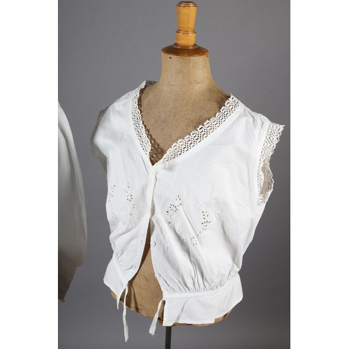 260 - An ornate Edwardian fine white cotton blouse with full sleeves, high neck and floral front embroider... 