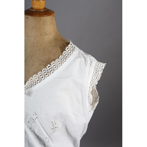 260 - An ornate Edwardian fine white cotton blouse with full sleeves, high neck and floral front embroider... 