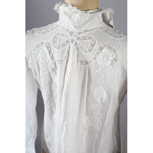 260 - An ornate Edwardian fine white cotton blouse with full sleeves, high neck and floral front embroider... 