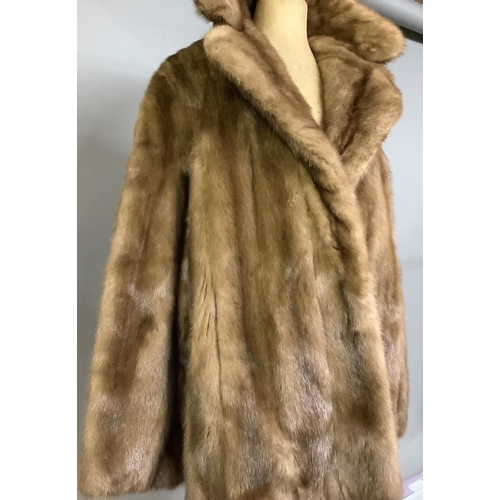 370 - A short light brown mink jacket, retailed by Dyson’s  Furriers Ltd, Leeds, size 14, lined in satin