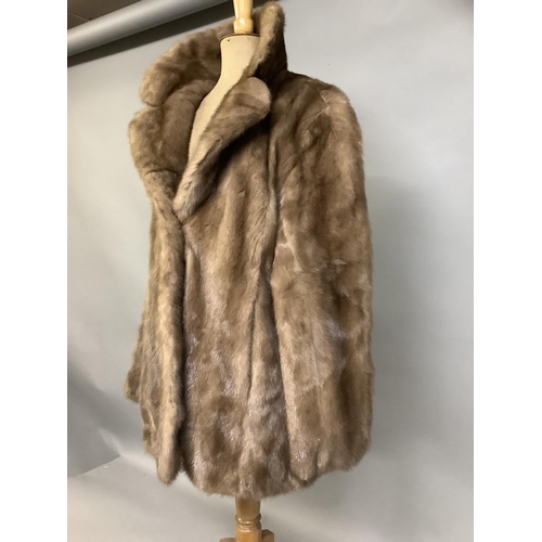 370 - A short light brown mink jacket, retailed by Dyson’s  Furriers Ltd, Leeds, size 14, lined in satin