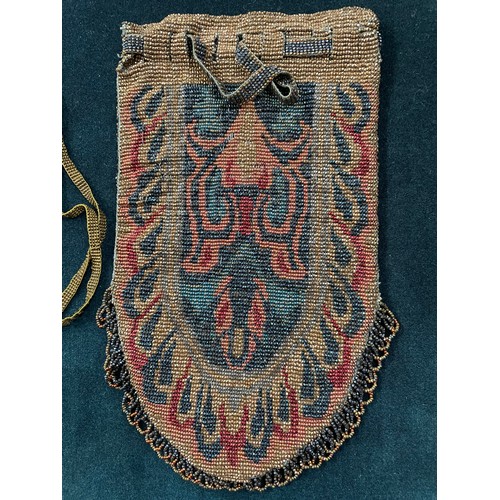 320 - Two early 20th century woven beaded bags, both with draw thread beaded straps, both fringed, neither... 