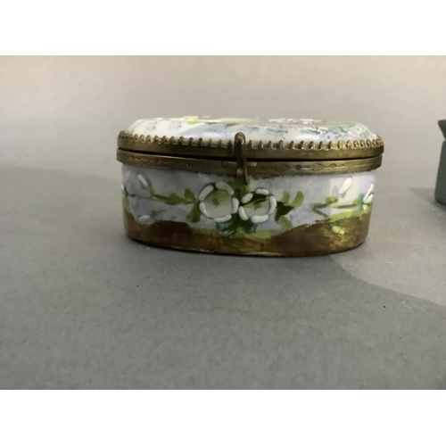 6 - A late 19th century china jewel casket of oval outline painted with flowers and butterflies to the l... 