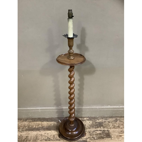 101 - A walnut barley twist standard lamp with circular tier and base with bun feet