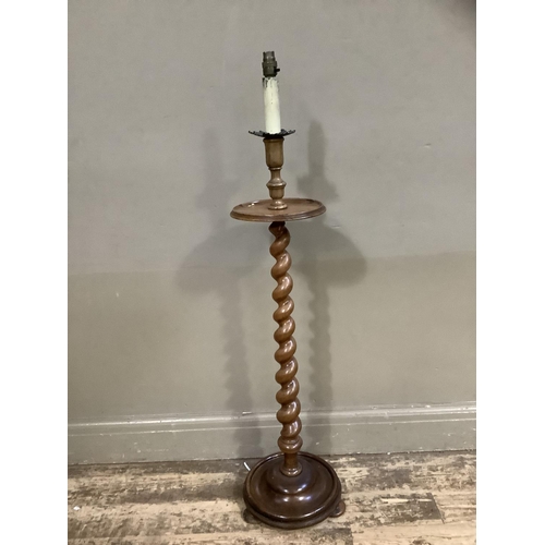 101 - A walnut barley twist standard lamp with circular tier and base with bun feet