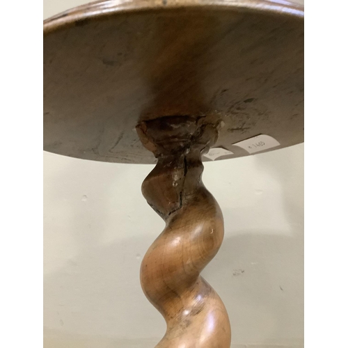 101 - A walnut barley twist standard lamp with circular tier and base with bun feet