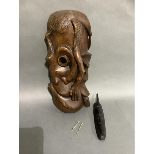 107 - A large carved African mask and a smaller ebonised mask