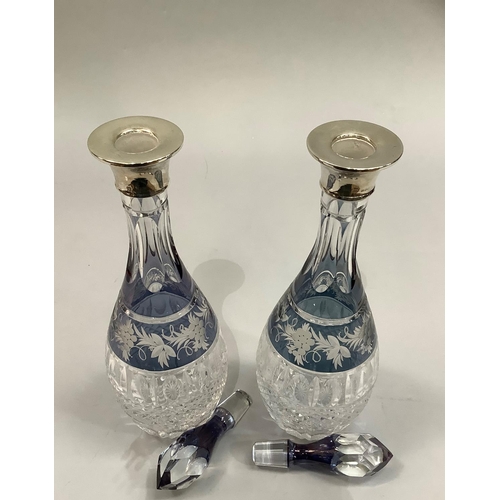 15 - A pair of George V fluted and hob nail cut glass decanters etched with a band of grape vines with si... 