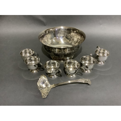 141 - A good silver plated punch bowl with six cups and ladle, embossed with flowers and blind cartouche,