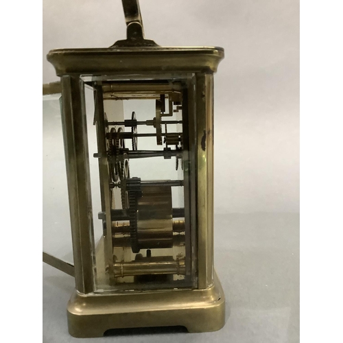 50 - A brass carriage clock circa 1900 having a gilt face with porcelain dial and with Arabic numerals in... 