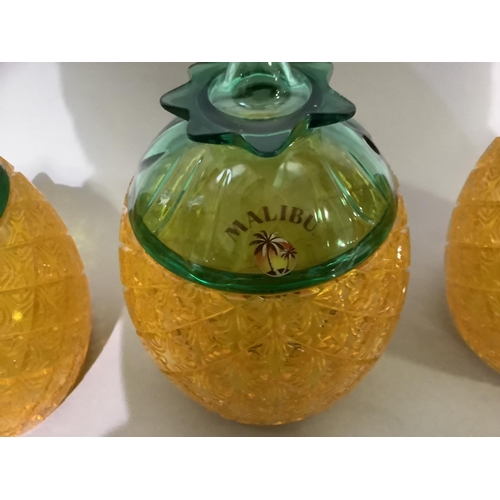 11 - A 1970's set of three plastic pineapple ice buckets labelled Malibu together with a teak and stainle... 