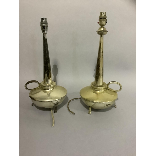 21 - A matched pair of silver plated table lamps with tapered columns and circular reservoirs, loop handl... 
