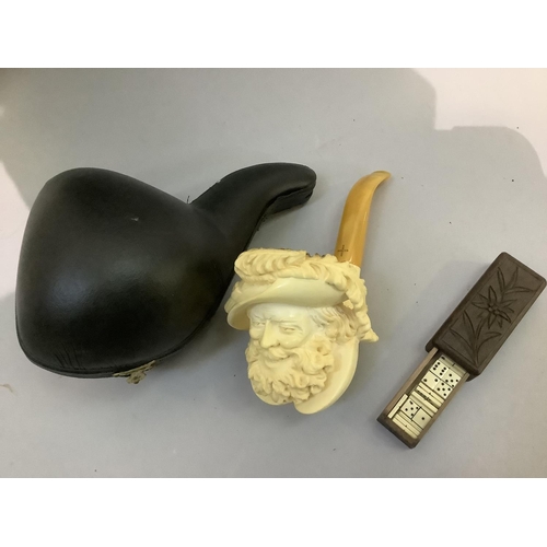 31 - A modern Meerschaum pipe, the bowl carved as a grinning bearded man with feathered hat, in fitted ca... 