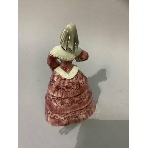 6 - A Goldscheider pottery figure of a female in pink flounced gown holding a letter, stamped and marked... 