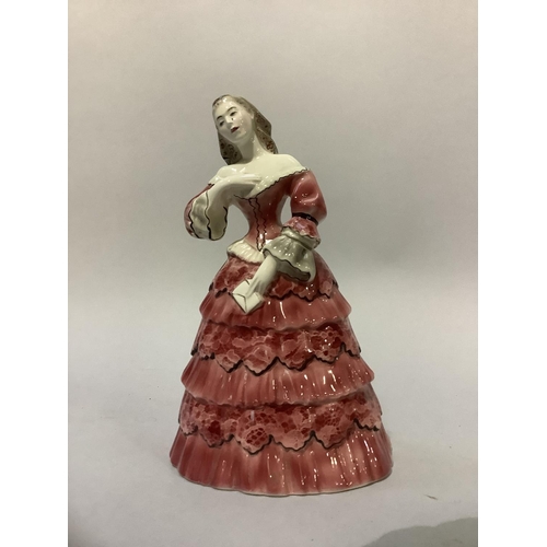 6 - A Goldscheider pottery figure of a female in pink flounced gown holding a letter, stamped and marked... 