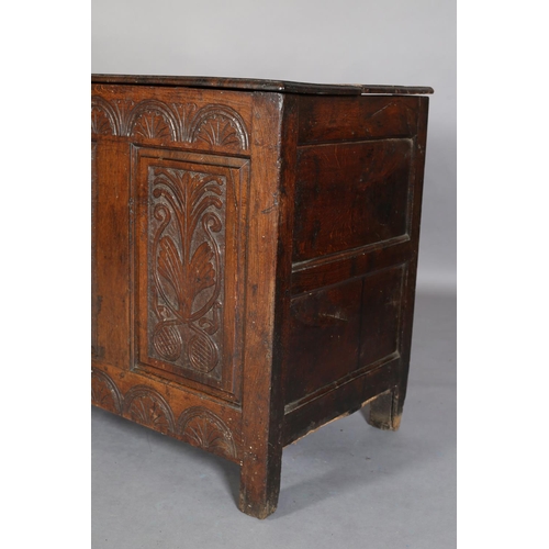 351 - AN 18TH CENTURY OAK JOINED CHEST, the planked top with slot in fastening demi-lune carved frieze and... 