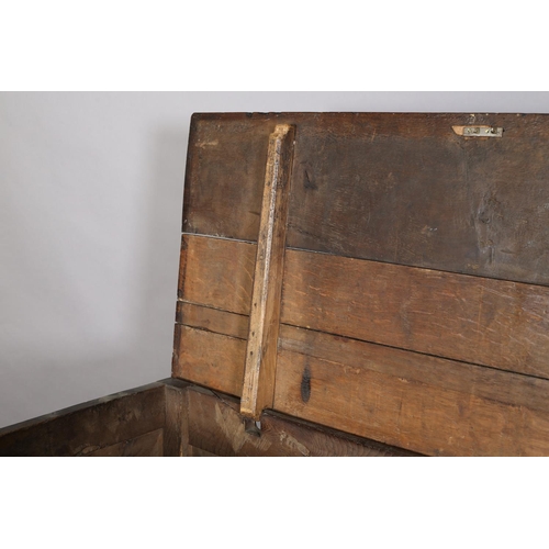 351 - AN 18TH CENTURY OAK JOINED CHEST, the planked top with slot in fastening demi-lune carved frieze and... 