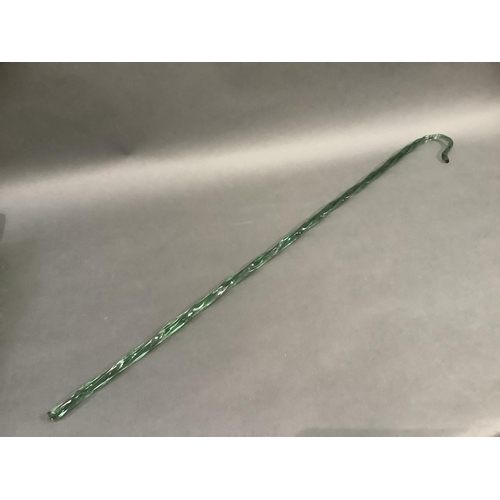 305 - A 19th century Nailsea type green wrythern glass walking cane, 107cm long