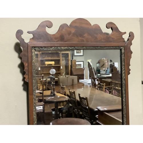 329 - An 18th century style mahogany fret cut wall mirror with rectangular glass measuring 63cm x 39cm