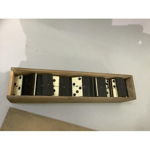 143 - Bone and ebonised dominoes in wooden box