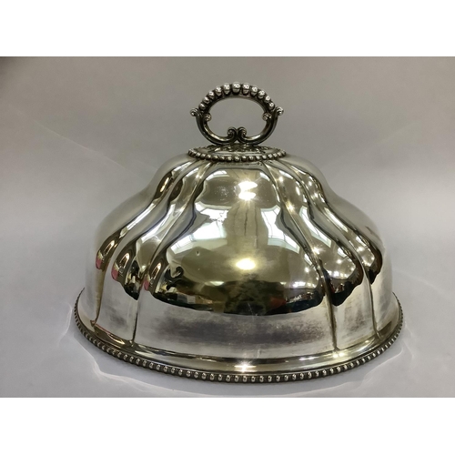 17 - An early 20th century silver plated meat cover of oval lobed form with beaded handle and rims, 46cm ... 