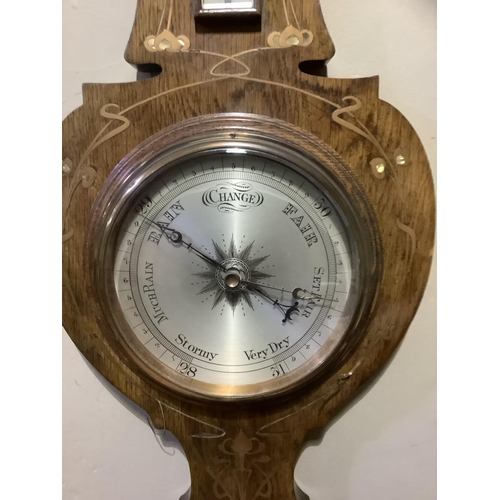 213 - An Art Nouveau oak barometer, inlaid in mother-of-pearl and copper 88cm high