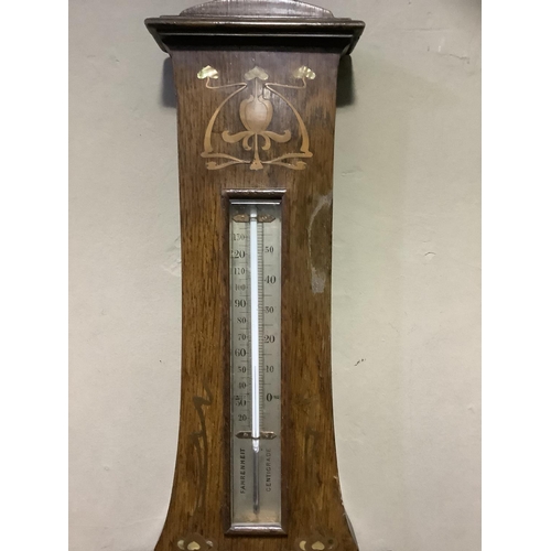 213 - An Art Nouveau oak barometer, inlaid in mother-of-pearl and copper 88cm high