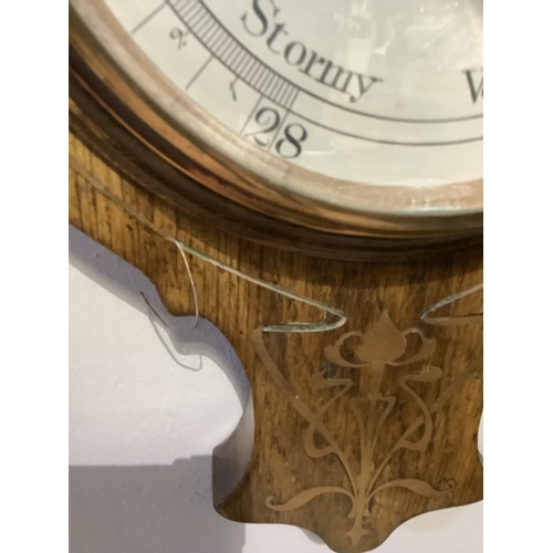 213 - An Art Nouveau oak barometer, inlaid in mother-of-pearl and copper 88cm high