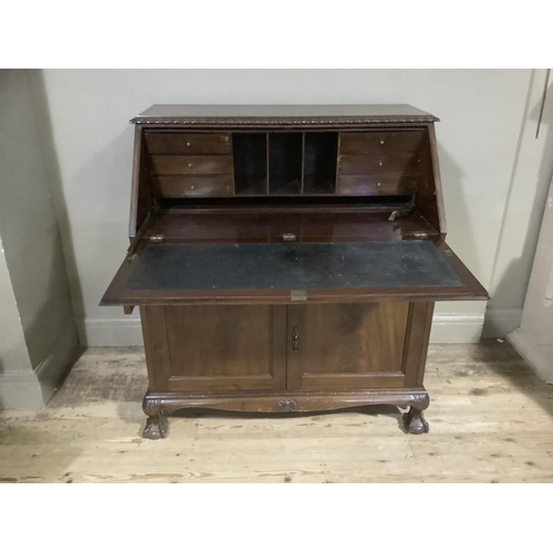 337 - A 1920s mahogany bureau having gadroon carved edges, twin indented panel fall front, fitted interior... 