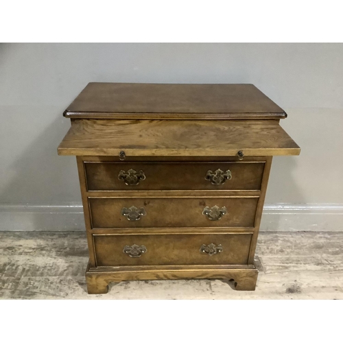 341 - A reproduction dwarf walnut crossbanded chest, having a pull out slide and four graduated drawers, b... 