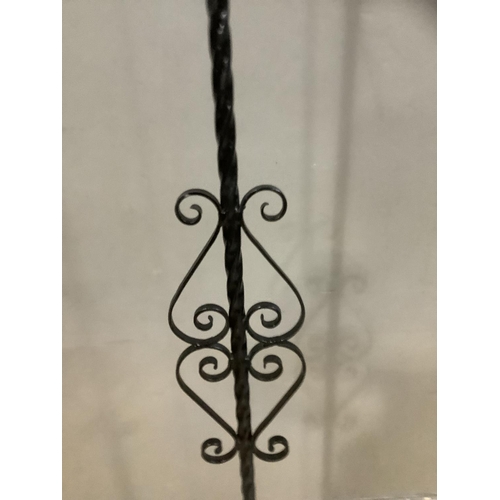 342 - A wrought iron standard lamp on tripod base with shade