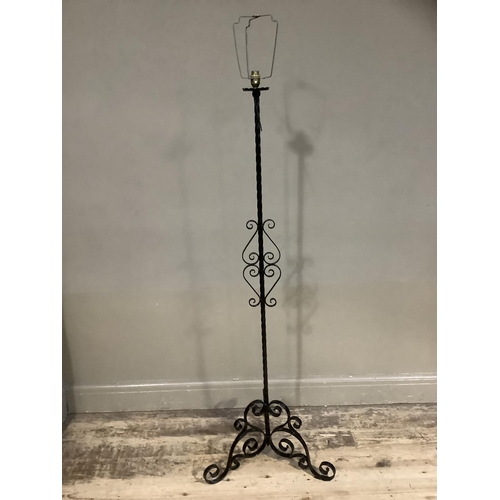 342 - A wrought iron standard lamp on tripod base with shade