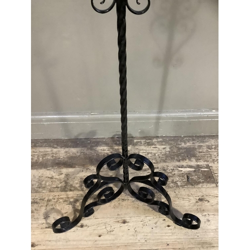 342 - A wrought iron standard lamp on tripod base with shade