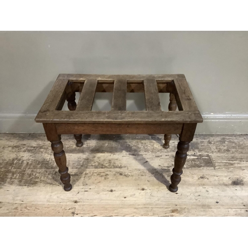 344 - An oak and elm luggage stand with slatted top on turned legs, 61cm x 38cm