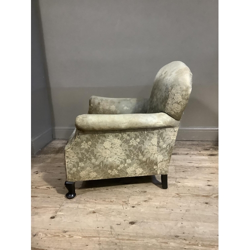 365 - An early 20th century upholstered armchair having a rounded back and on short cabriole legs with pad... 