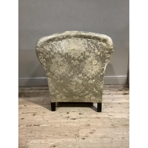 365 - An early 20th century upholstered armchair having a rounded back and on short cabriole legs with pad... 