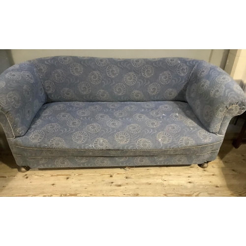 366 - An early 20th century Chesterfield sofa having a rolled back and arms, upholstered in the original p... 