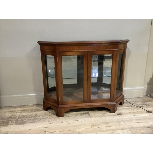 91 - A mahogany and glazed four door display cabinet on shaped bracket feet with lights