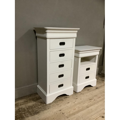 92 - A cream finished chest of five drawers with recessed handles  on shaped bracket feet together with a... 